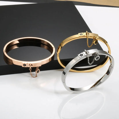 LuxéGlow™ Golden Stainless Steel Jewelry Set – Unisex Bangle Bracelet & Flower Charm Ring