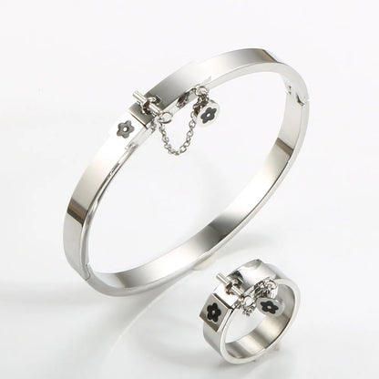 LuxéGlow™ Golden Stainless Steel Jewelry Set – Unisex Bangle Bracelet & Flower Charm Ring