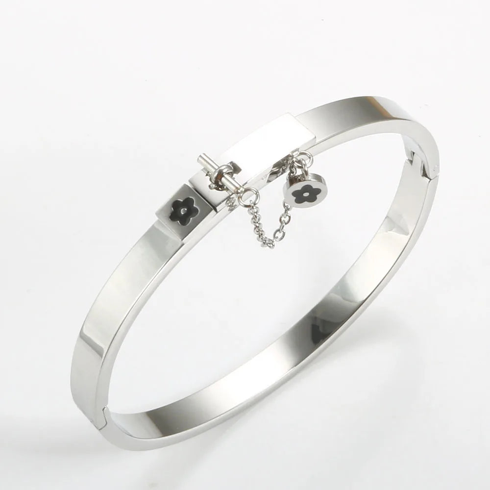 LuxéGlow™ Golden Stainless Steel Jewelry Set – Unisex Bangle Bracelet & Flower Charm Ring