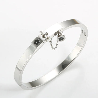 LuxéGlow™ Golden Stainless Steel Jewelry Set – Unisex Bangle Bracelet & Flower Charm Ring